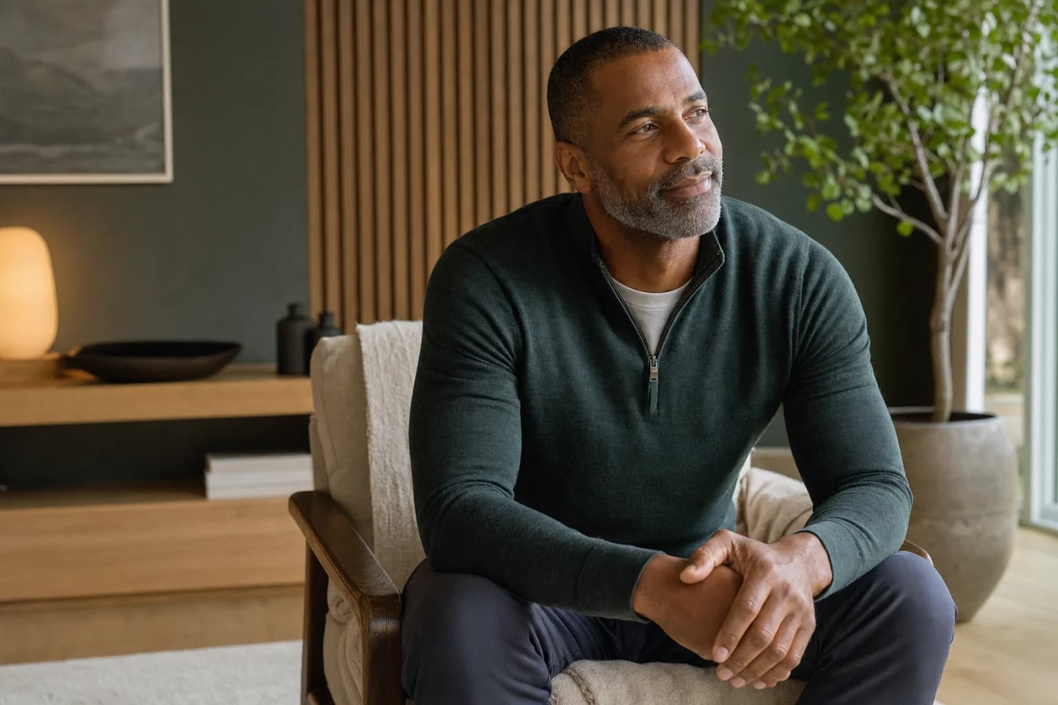 A relaxed man seated in a calm private wellness studio